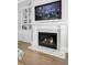 Marble fireplace surround with mounted television and built-in shelving at 1098 Reserve Ln, Awendaw, SC 29429