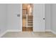 This hallway features carpet, neutral walls, and a glimpse of the stairwell at 1098 Reserve Ln, Awendaw, SC 29429