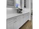 Elegant white countertops and cabinets with a stylish espresso machine, perfect for coffee enthusiasts at 1098 Reserve Ln, Awendaw, SC 29429