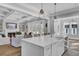 Open-concept kitchen featuring a large white island with pendant lighting and seamless flow into the living area at 1098 Reserve Ln, Awendaw, SC 29429