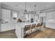 Well-lit kitchen showcasing a large island with seating and stainless steel appliances at 1098 Reserve Ln, Awendaw, SC 29429