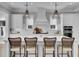 Modern kitchen with white cabinets, subway tile backsplash, and large island with seating at 1098 Reserve Ln, Awendaw, SC 29429