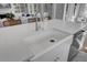 Kitchen island with a white countertop, stainless steel faucet, and sink at 1098 Reserve Ln, Awendaw, SC 29429