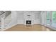Cozy living room with fireplace, built-in shelving, and access to a porch at 1098 Reserve Ln, Awendaw, SC 29429