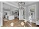 Open floor plan showcasing hardwood floors, recessed lighting, and a modern kitchen in the background at 1098 Reserve Ln, Awendaw, SC 29429