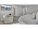Bright main bedroom featuring a comfortable chair, wall-mounted television, and ensuite bathroom and closet entries at 1098 Reserve Ln, Awendaw, SC 29429