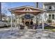 Outdoor fireplace and living area with vaulted ceiling and comfortable seating at 1098 Reserve Ln, Awendaw, SC 29429
