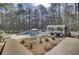 Backyard pool area surrounded by towering trees and lounge furniture at 1098 Reserve Ln, Awendaw, SC 29429