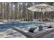 Pool featuring elevated lounge area, sun umbrella and backyard view at 1098 Reserve Ln, Awendaw, SC 29429