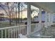 Inviting front porch with comfortable seating overlooking lush landscaping and a serene community at sunset at 1098 Reserve Ln, Awendaw, SC 29429