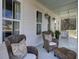 Inviting porch with rocking chairs and decorative pillows creates a cozy outdoor seating area at 1098 Reserve Ln, Awendaw, SC 29429