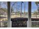 Scenic view from the porch overlooking a serene lake and lush green landscape at 1098 Reserve Ln, Awendaw, SC 29429