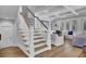Elegant staircase with wooden steps and white railings, leading to the upper level of the home at 1098 Reserve Ln, Awendaw, SC 29429