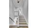Staircase with wooden steps and white railings leading upstairs, offering a glimpse of the interior design at 1098 Reserve Ln, Awendaw, SC 29429