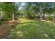 Expansive backyard features a lush lawn, mature trees, and a wooden fence for added privacy at 1129 Shady Grove Ln, Mount Pleasant, SC 29464