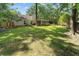 Spacious backyard with manicured lawn, mature trees and outdoor living area at 1129 Shady Grove Ln, Mount Pleasant, SC 29464