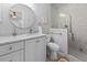 Bright bathroom featuring a white vanity with marble countertop, a round mirror and a glass enclosed shower at 1129 Shady Grove Ln, Mount Pleasant, SC 29464