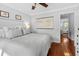 Well-lit bedroom features a calming color scheme, a decorative painting, and an open doorway at 1129 Shady Grove Ln, Mount Pleasant, SC 29464