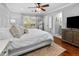 Bright bedroom featuring hardwood floors, and a doorway leading to an en-suite bathroom at 1129 Shady Grove Ln, Mount Pleasant, SC 29464