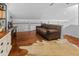 Open loft area with hardwood floors, brown sofa and built-in bar area at 1129 Shady Grove Ln, Mount Pleasant, SC 29464