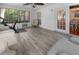 Bright sunroom featuring a white ceiling fan, modern exercise bike, and white-trimmed windows at 1129 Shady Grove Ln, Mount Pleasant, SC 29464