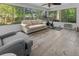 Bright sunroom with neutral furniture, exercise equipment, and scenic backyard views at 1129 Shady Grove Ln, Mount Pleasant, SC 29464