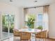 Charming dining area with a view of a serene lake and a glass sliding door to the outside at 114 Rust Rail Way, Summerville, SC 29485