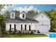 Charming single-Gathering home featuring a stone foundation and inviting front porch with rocking chairs at 114 Rust Rail Way, Summerville, SC 29485