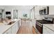 Modern kitchen features white cabinets, stainless steel appliances, and an open layout to the breakfast nook at 114 Rust Rail Way, Summerville, SC 29485
