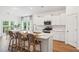Kitchen with island seating has stainless appliances and white cabinetry, which creates a functional and stylish kitchen space at 114 Rust Rail Way, Summerville, SC 29485
