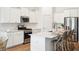 Bright, modern kitchen with white cabinets, stainless steel appliances, and a large island with bar seating at 114 Rust Rail Way, Summerville, SC 29485