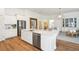 Elegant kitchen showcases a large island with seating, stainless appliances, and seamless transition to the dining area at 114 Rust Rail Way, Summerville, SC 29485