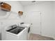 Functional laundry room with washer, dryer, and shelving for storage at 114 Rust Rail Way, Summerville, SC 29485