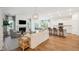 Open-concept living area with hardwood floors, a fireplace, and a bright kitchen, ideal for entertaining at 114 Rust Rail Way, Summerville, SC 29485