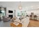 Bright, open living area with fireplace, modern lighting, and seamless flow to kitchen and dining, perfect for entertaining at 114 Rust Rail Way, Summerville, SC 29485