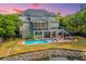 Beautiful home from an aerial view, showcasing a private pool, solar panels and landscaped backyard at 1143 Sea Eagle Watch, Charleston, SC 29412
