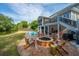 Backyard retreat featuring a pool, fire pit, comfortable seating, and tranquil views of a pond at 1143 Sea Eagle Watch, Charleston, SC 29412