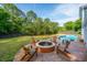 Inviting backyard with pool, fire pit, lush greenery, and outdoor seating for relaxation and entertainment at 1143 Sea Eagle Watch, Charleston, SC 29412