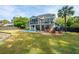 Expansive backyard with a pool, fire pit, lush lawn, and a multi-level deck perfect for outdoor living at 1143 Sea Eagle Watch, Charleston, SC 29412