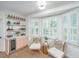 Stylish bar area featuring a wine cooler, marble countertop, custom shelving, and natural light at 1143 Sea Eagle Watch, Charleston, SC 29412