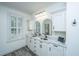 Bright bathroom with a double sink vanity, marble countertop and floor, and modern fixtures at 1143 Sea Eagle Watch, Charleston, SC 29412