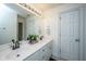 Bright bathroom with double sinks, a large mirror, white cabinets, and modern fixtures at 1143 Sea Eagle Watch, Charleston, SC 29412