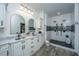 Elegant bathroom with double sinks, marble countertop, and large walk-in shower with mosaic tile accents at 1143 Sea Eagle Watch, Charleston, SC 29412