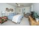 Inviting bedroom with a queen bed, soft blue bedding, and natural light from shuttered windows at 1143 Sea Eagle Watch, Charleston, SC 29412