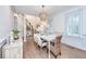 Light-filled dining area with stylish table, elegant decor, and plantation shutters at 1143 Sea Eagle Watch, Charleston, SC 29412