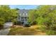 Beautiful two-story home with a well-manicured lawn, mature trees, and inviting double porches at 1143 Sea Eagle Watch, Charleston, SC 29412