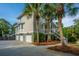 Spacious three-car garage with an adjacent staircase leading to the home's rear outdoor living area at 1143 Sea Eagle Watch, Charleston, SC 29412