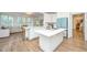 Open kitchen featuring white cabinets, marble countertops, stainless appliances and a breakfast bar at 1143 Sea Eagle Watch, Charleston, SC 29412