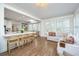 Open concept kitchen featuring white cabinets, marble countertops, and a cozy seating area with natural lighting at 1143 Sea Eagle Watch, Charleston, SC 29412