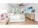 Bright main bedroom featuring a ceiling fan, bedside tables, a dresser, and a seating area at 1143 Sea Eagle Watch, Charleston, SC 29412
